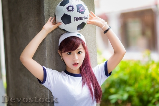 Devostock Girl HIGH SCHOOL PLACING SOCCER BALL HEAD