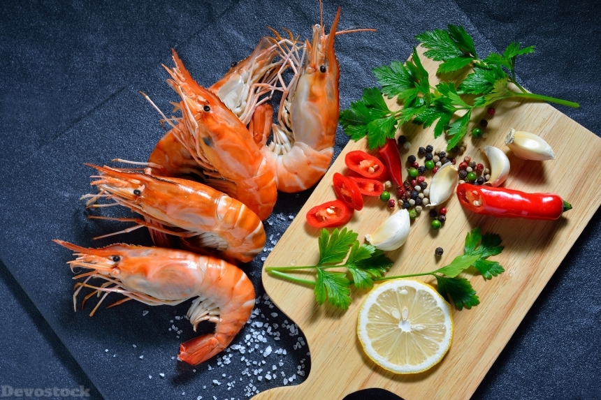 Devostock Cooked shrimps,prawns with seasonings on stone background