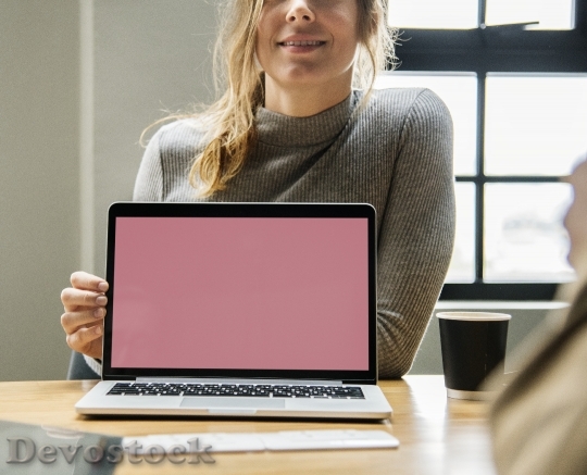 Devostock Blond woman pointing at a laptop screen