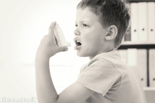 Devostock Boy using an asthma inhaler
