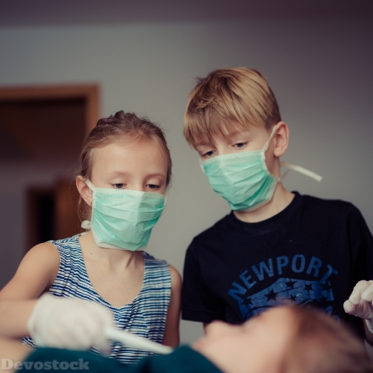 Devostock Beautiful CHILDREN PLAYING DOCTORS Masked