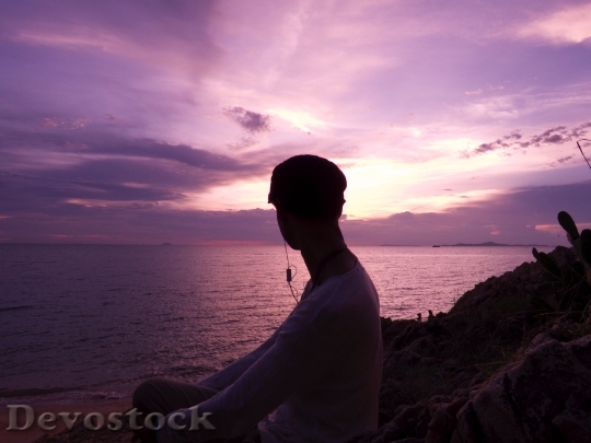 Devostock Person Sunset Beach Relaxation 4K.jpeg