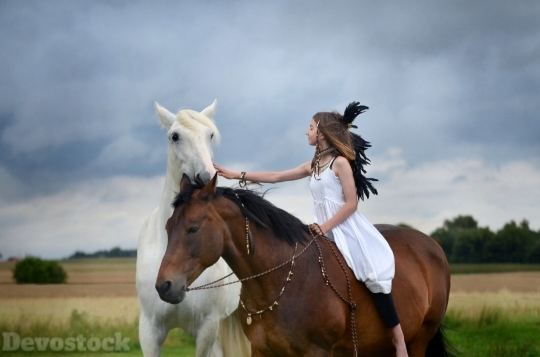 Devostock Beautiful Little Girl Outdoor Smiling Riding Horse 4k
