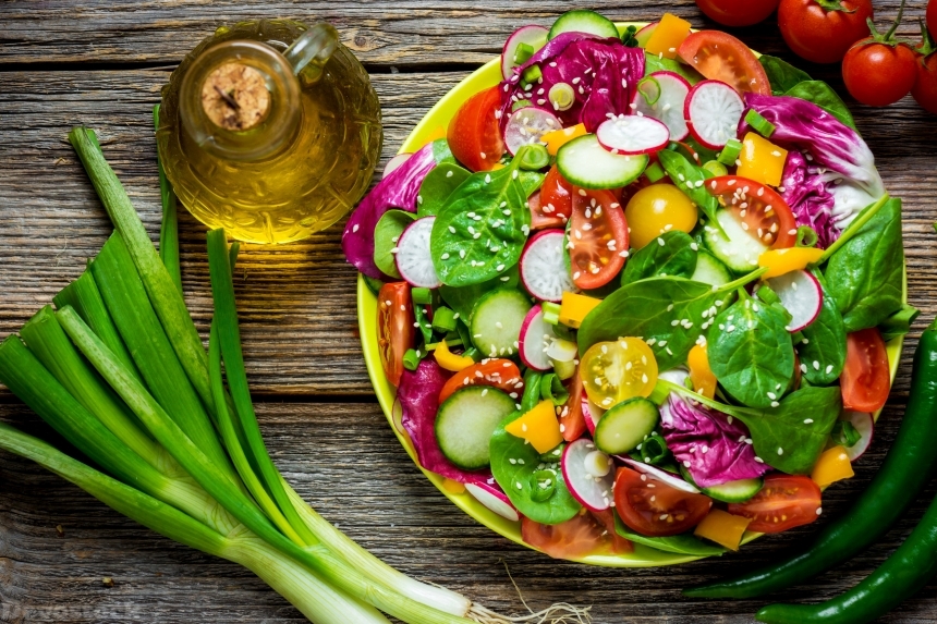 Devostock Fresh vegetable salad on wooden background