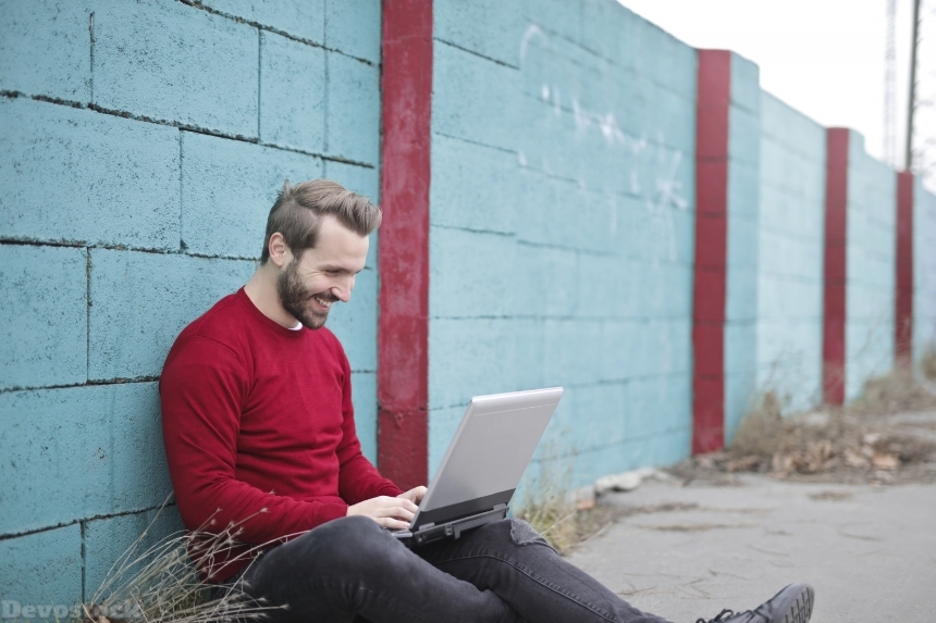 Devostock Man Wall Sitting Smiling Laptop Jeans 4k