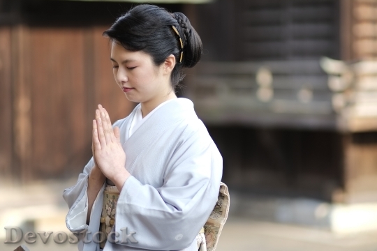 Devostock A Japanese girl worshiping in kimono