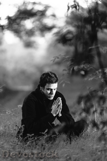Devostock A man meditating in the forest BAW