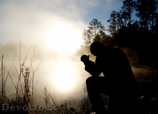 Devostock A man praying and hoping