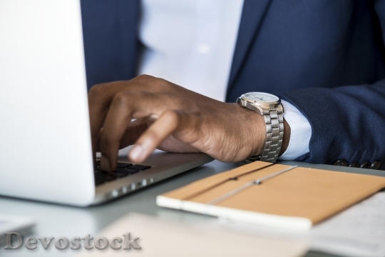 Devostock Black businessman using computer laptop
