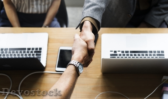 Devostock Business people shaking hands in agreement