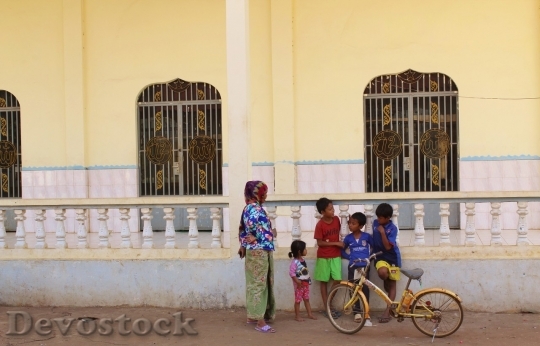 Devostock Children standing with bike