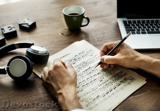 Devostock Closeup on casual man composing music