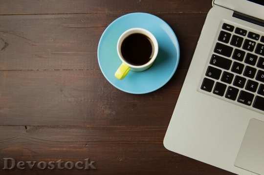 Devostock Coffee cup and laptop computer on office table