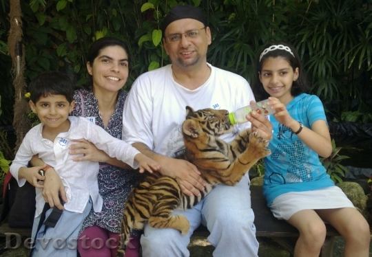 Devostock Family holding tiger