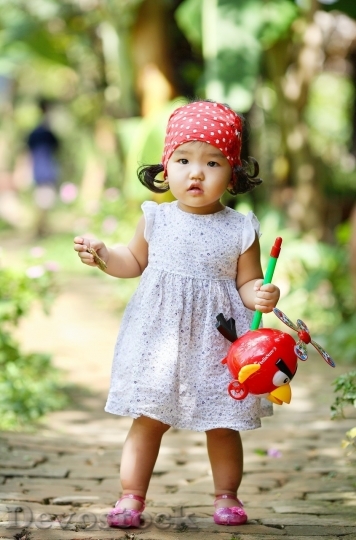 Devostock Little girl playing in the wood