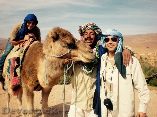 Devostock Men with a camel