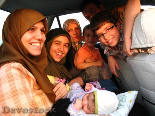 Devostock Muslim family at the car smiling