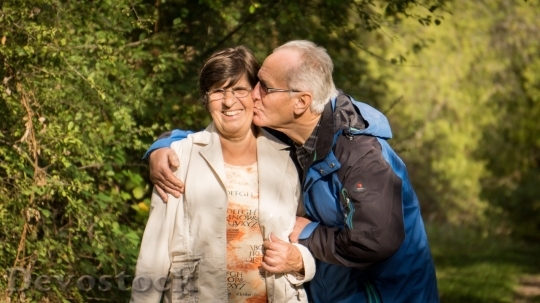 Devostock Old man kissing his woman
