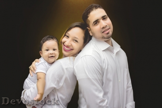 Devostock Smiling family with baby boy