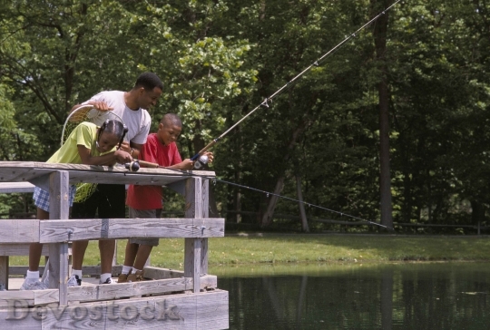 Devostock Family Fishing From Bridge