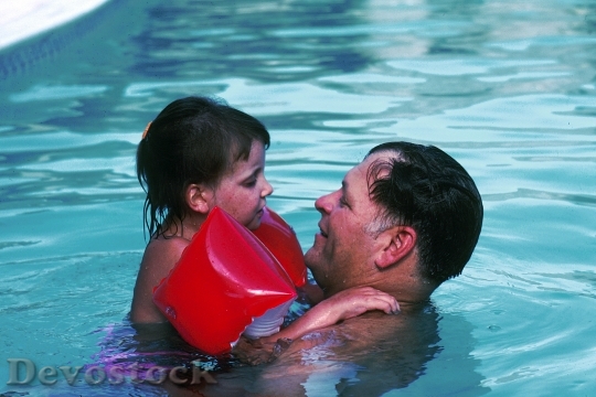 Devostock Father Daughter In Pool
