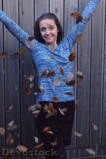 Devostock Girl Autumn Leaves Fun