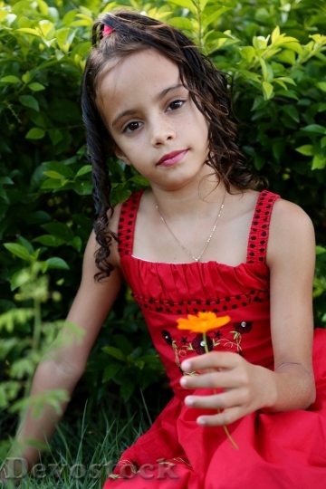 Devostock Girl Looking Holding Flower