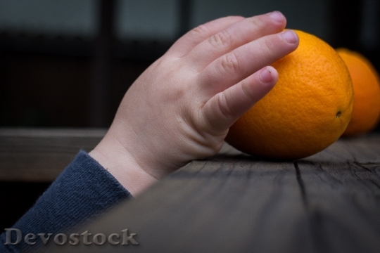Devostock Hand Grabbing Taking Orange