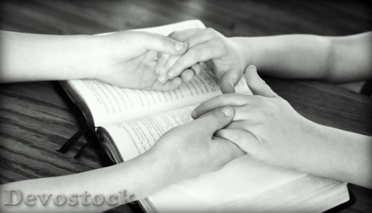 Devostock Holding Hands Bible Praying