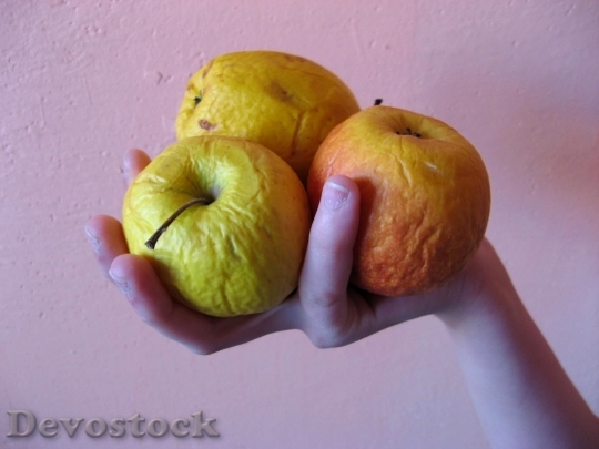 Devostock Three Apples In Hand