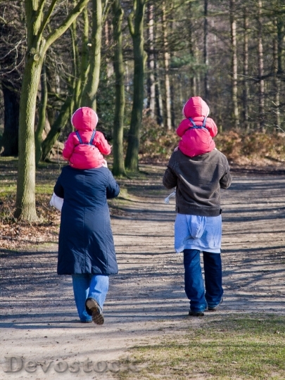 Devostock Twins Parents Walking Mother