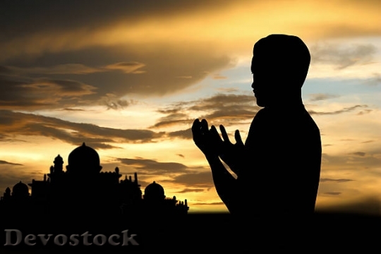 Devostock muslim-boy-in-prayer-at-sunset-picture-id473458484$1