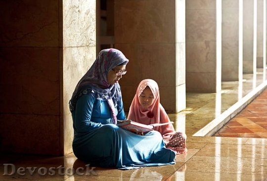 Devostock muslim-mother-teach-her-daughter-reading-koran-pic$1