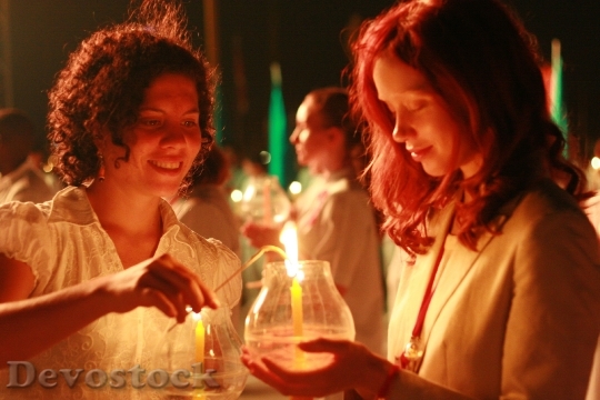 Devostock Buddhists Women Candles Ceremony