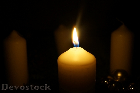Devostock Candle On Black Background
